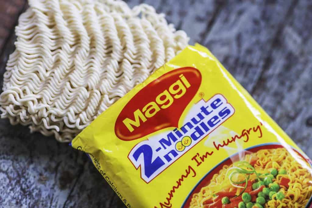 An open packet of Maggi 2-Minute Noodles, manufactured by Nestle India Ltd., are arranged for a photograph inside a general store in Mumbai, India, on Tuesday, June 2, 2015. Nestle, one of India's biggest processed food makers, slid to the lowest in a month after a complaint was filed in a local court over lead levels in its Maggi instant noodles. Photographer: Dhiraj Singh/Bloomberg via Getty Images